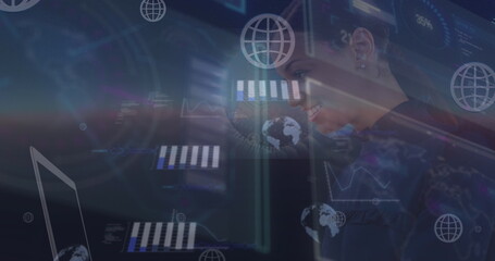 Image of moving graphs and computer network icons over happy businesswoman using laptop
