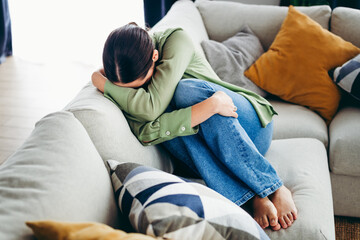 Charming woman relaxing on a cozy sofa in a modern living room during a peaceful day