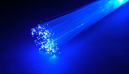 Obraz premium Glowing blue fiber optic strands on dark background. Abstract technology image. Perfect for backgrounds, websites, or presentations.