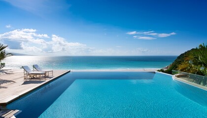 Fototapeta premium luxury beachfront villa with infinity pool overlooking clear blue ocean