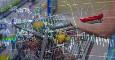 Image of financial data processing over shopping cart