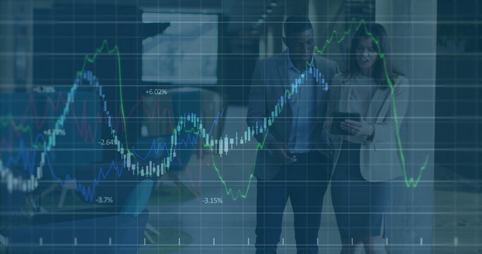 Image of graph data moving over multiracial partners discussing with tablet in office lobby