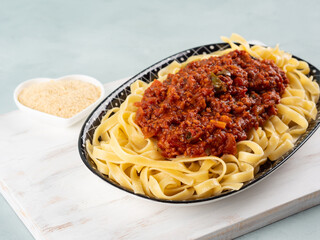 Tagliatelle with vegan tomato bolognese ragu with soya protein granules