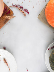 Fall thanksgiving table setting pumpkin decor concept flatlay on gray