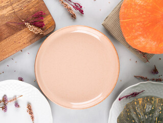 Fall thanksgiving table setting pumpkin decor flatlay with pink dish