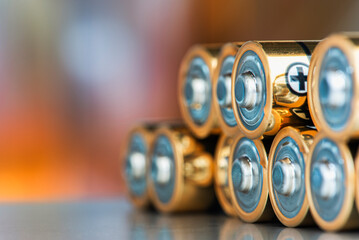 AA alkaline batteries lying down with a blurred industrial background