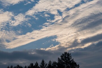 Soft white clouds in blue sky at dawn - natural background