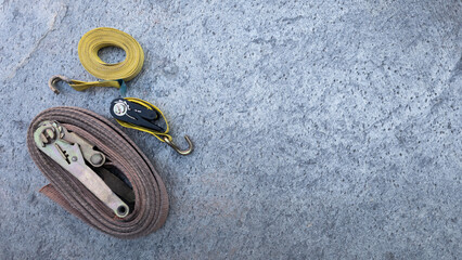 Ratchet straps on the concrete surface, ensuring high -strength load transport equipment. Copy space