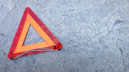 Emergency stop warning against the danger of the vehicle, on the textured asphalt surface. Copy space