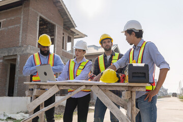 Construction workers collaborating on a building project at a construction site in the daytime