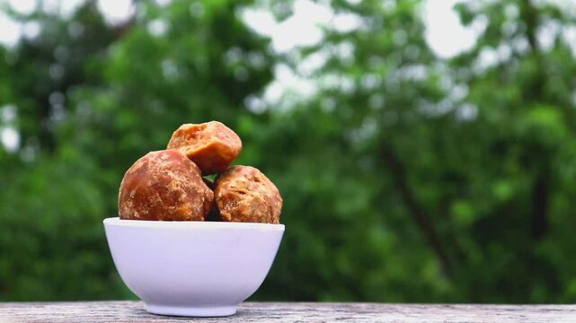 Organic Palm Jaggery in a White Bowl with Selective Focus and Copy Space