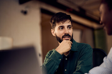 Businessman Engaging in Conversation at Modern Office Setting with Colleague