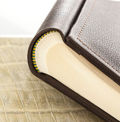 Elegant leather photo album showing its spread pages on textured surface