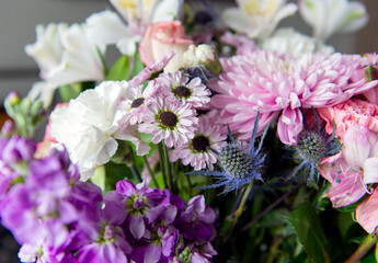 Fresh colorful bouquet with pink chrysanthemum, roses and white lilies close-up