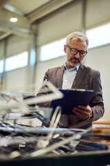 Professional Engineer Conducting Quality Inspection in a Modern Industrial Facility