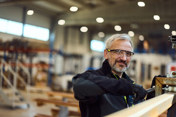 Experienced Craftsperson Working in a Modern Workshop With Safety Gear