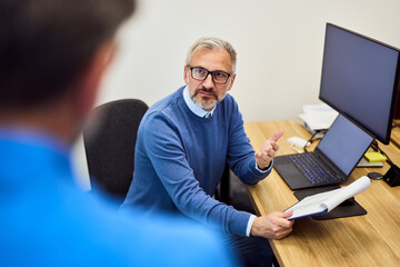 Business Discussion Between Coworkers in a Modern Office Setting
