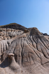 Surreal Badlands Sandstone Formations near Drumheller, Land of hoodoos, multi-hued canyons and geological erosion sculptured by water and wind
