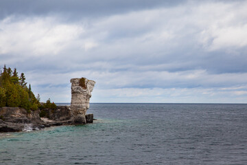Vase Shape Limestone Rock Formation standing on Lake Huron Georgian Bay Coast. Flowerpot Island, Ontario, Canada