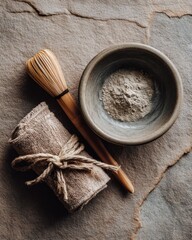 Japanese tea ceremony essentials with bamboo whisk and matcha powder on textured background for zen decor
