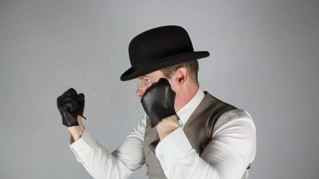 Vintage Ruffian or Back Alley Brawler in Bowler Hat and Leather Gloves Standing in Fighting Stance