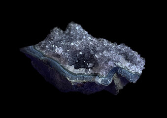 Macro Mineral Stone Amethysts from Brazil isolated on black background.