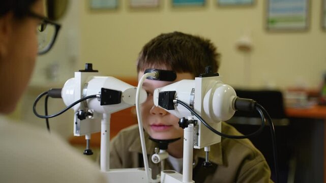 Young boy undergoing comprehensive eye examination with optometrist
