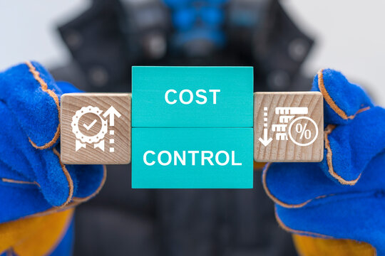 Worker holding colorful blocks with icons sees inscription: COST CONTROL. Cost and quality control, industry strategy and project management concept. Cost reduction and effective manufacturing.