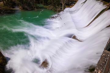 water outflow through the dam of a small hydroelectric dam, long exposure, La Rocha Dam, Zaorejas, Guadalajara, Spain