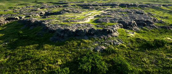 Rocky Terrain Covered In Green Grass
