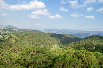 Landscape with Lush Green Mountain Range Under a Bright Blue Sky with Clouds. Dalat, Vietnam.