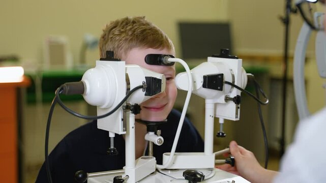 Young boy undergoing synoptophore eye examination by doctor