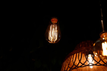 Warm glowing vintage halogen decorative bulbs on black background