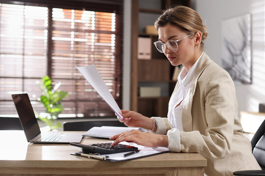 Professional banker working at desk in office - Powered by Adobe