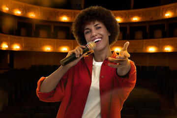 Beautiful woman singing on stage in concert hall