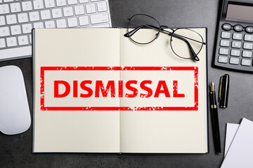 Word Dismissal in notebook on grey table. Office workplace, top view