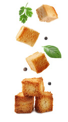 Delicious crispy croutons, herbs and peppercorns falling on white background