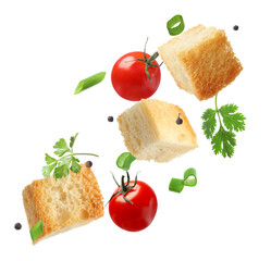 Delicious crispy croutons, tomatoes, peppercorns and herbs flying on white background