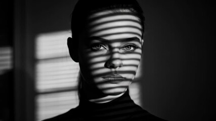 Intense black and white portrait of a young adult female with striking shadows from blinds - Powered by Adobe
