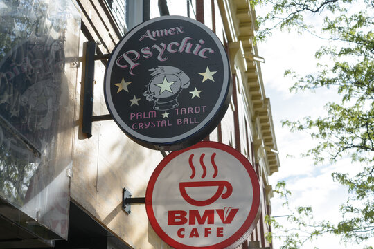 projecting storefront signs for Annex Psychic and BMV Cafe located at 475 and  471 Bloor St W, Toronto