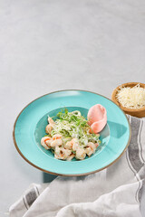 Gourmet Shrimp Pasta in Cream Sauce on Pastel Plate with Artistic Lighting