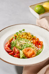 Vibrant Salmon Bowl with Fresh Vegetables and Corn in Natural Lighting