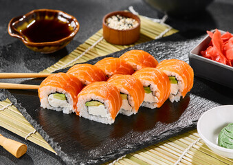 Philadelphia roll with salmon, avocado, and cream cheese on slate plate, bright lighting, vibrant color