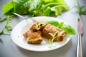 Omelette rolled up with green herbs, top view
