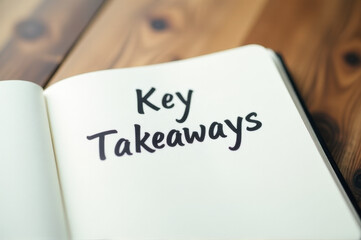 A book with notes and summaries from a presentation or meeting, featuring the phrase 'key takeaways'