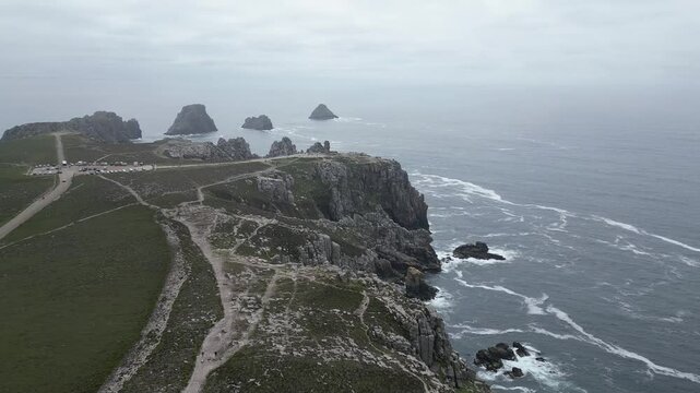 Drone footage of the rocky coastline at Pointe de Pen-Hir on the Crozon Peninsula, Brittany, France, on a cloudy day.