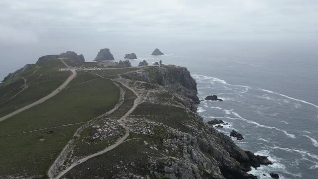 Drone footage of the rocky coastline at Pointe de Pen-Hir on the Crozon Peninsula, Brittany, France, on a cloudy day.