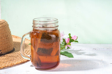 Sun Tea in mason jar, sun brew tea drink on wooden table