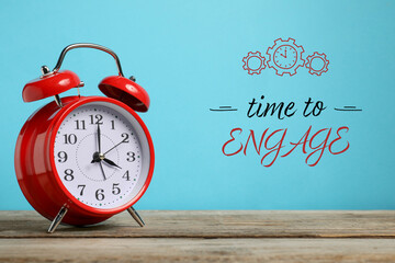 Time to engage. Red alarm clock and words on light blue background