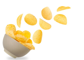 Tasty crispy potato chips falling into bowl on white background